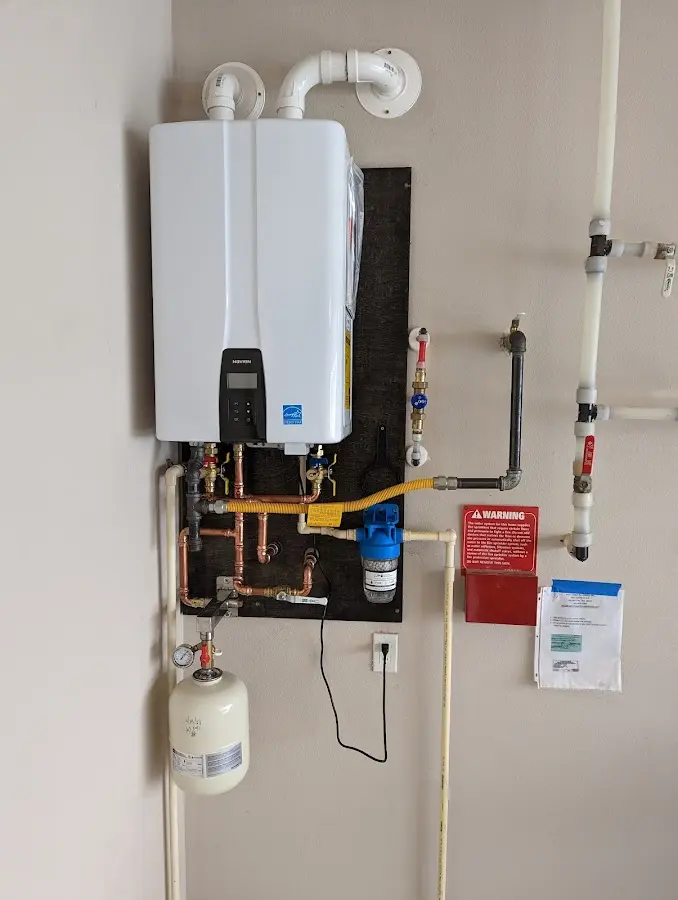 Professional plumber installing copper piping in a Weslaco home